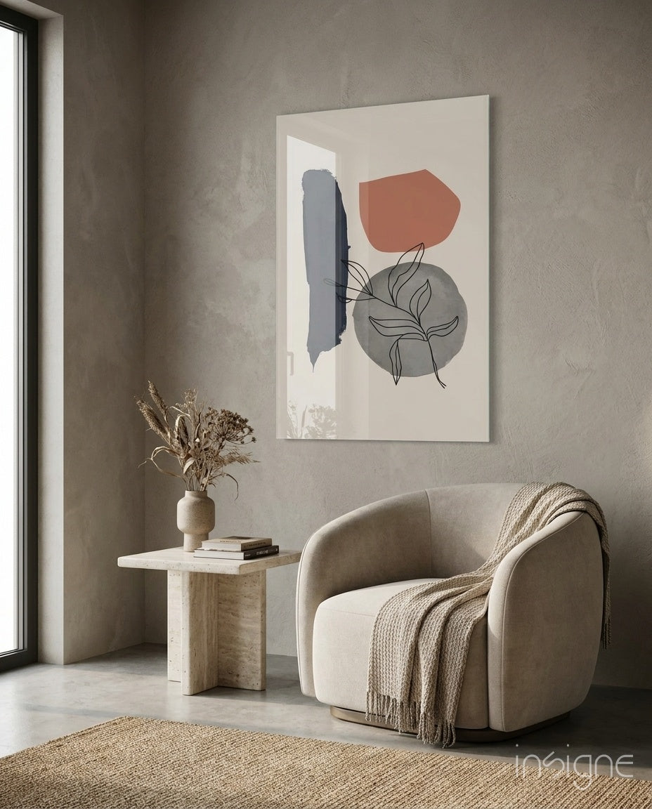 Leaf Circle glass wall art displayed above a travertine side table in a warm earth-toned lounge with bouclé chair