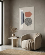 Leaf Circle glass wall art displayed above a travertine side table in a warm earth-toned lounge with bouclé chair