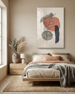 Leaf Branch glass wall art displayed above an upholstered headboard in a warm beige bedroom