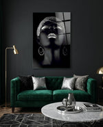 Silver Crown glass wall art displayed above an emerald velvet sofa in a charcoal-walled lounge with brass lamp