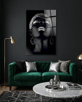 Silver Crown glass wall art displayed above an emerald velvet sofa in a charcoal-walled lounge with brass lamp