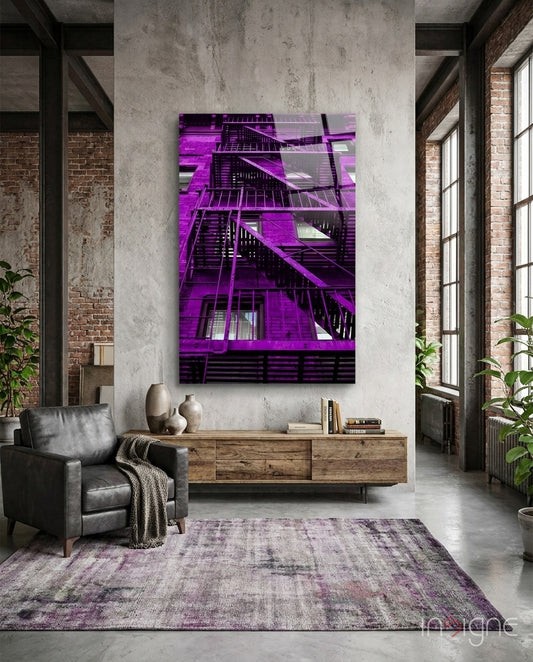 Purple Stairs glass wall art displayed above a wood credenza in an industrial concrete-walled lounge with charcoal leather chair