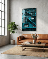 Blue Stairs glass wall art displayed above a cognac leather sofa in a light concrete-walled lounge