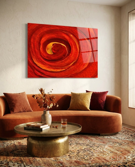 Red Vortex glass wall art displayed above a curved rust velvet sofa in a warm beige lounge with brass coffee table