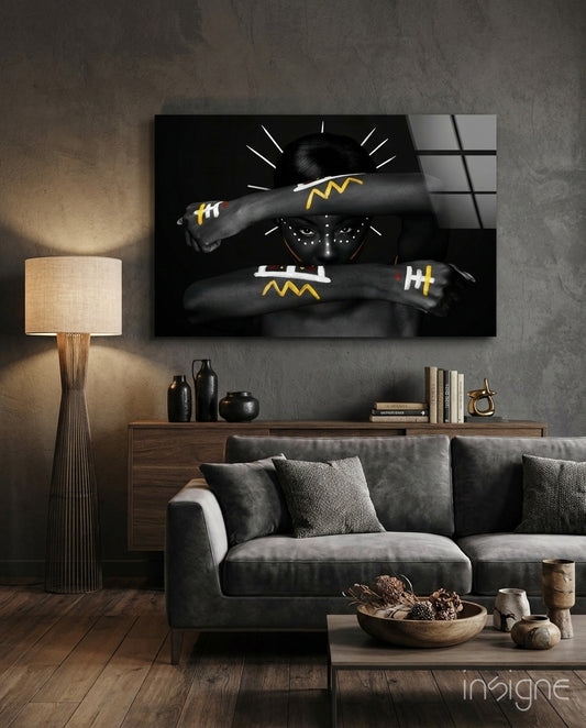 Tribal Spirit glass wall art displayed above a walnut credenza in a warm wood-paneled lounge with grey velvet sofa