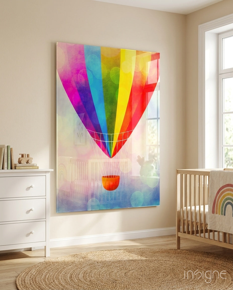 Rainbow Balloon glass wall art displayed above a wood crib in a soft beige nursery with rainbow mobile