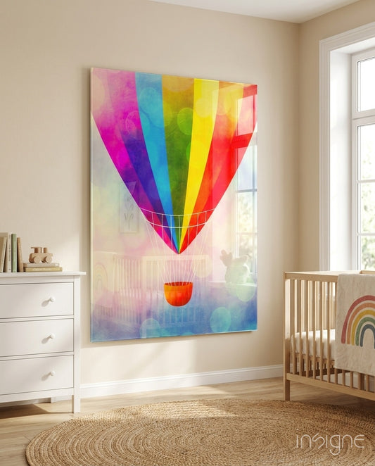 Rainbow Balloon glass wall art displayed above a wood crib in a soft beige nursery with rainbow mobile