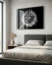 Dandelion Wish glass wall art displayed above a charcoal upholstered headboard in a greige bedroom