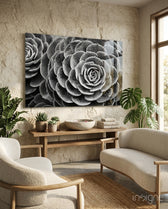 Silver Succulent glass wall art displayed above a wood console in a warm sandstone-walled lounge with bouclé chairs