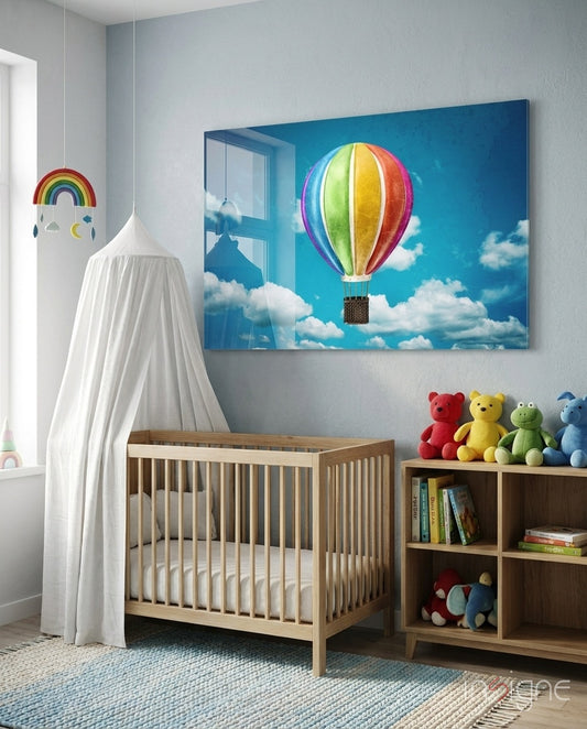 Sky Balloon glass wall art displayed above a wood crib in a soft blue nursery with stuffed animals