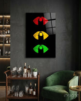 Lip Signal glass wall art displayed above a wood bar cart in a charcoal-walled lounge with emerald velvet armchair