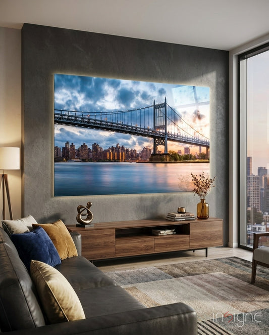 Triboro Bridge glass wall art displayed above a walnut credenza in a warm grey city-view lounge with charcoal sectional