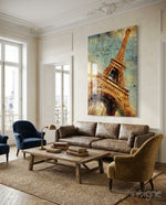 Paris Poster glass wall art displayed above a brown leather sofa in a classical Parisian apartment with herringbone floor