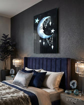 Crescent Garland glass wall art displayed above a navy velvet headboard in a dark moody bedroom with crystal lamps