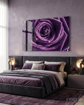 Purple Rose glass wall art displayed above an upholstered headboard in a lavender-walled bedroom with purple bedding