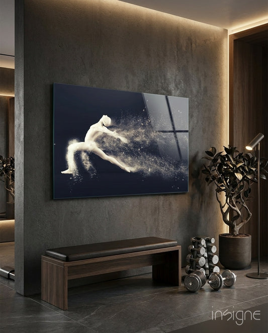 Particle Dance glass wall art displayed above a wood bench in a dark concrete-walled gym with dumbbells