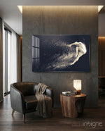 Spirit Leap glass wall art displayed above a walnut side-table in a dark concrete-walled lounge with charcoal leather chair