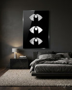 Silver Lip Stack glass wall art displayed above a charcoal upholstered headboard in a moody charcoal bedroom