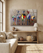 Colorful Zebras glass wall art displayed above a console in a designer interior
