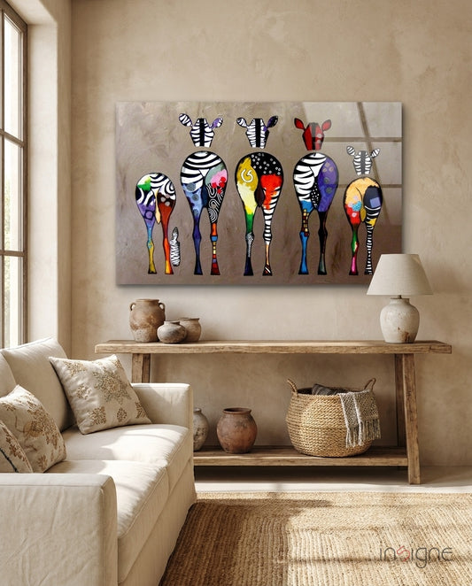 Colorful Zebras glass wall art displayed above a console in a designer interior