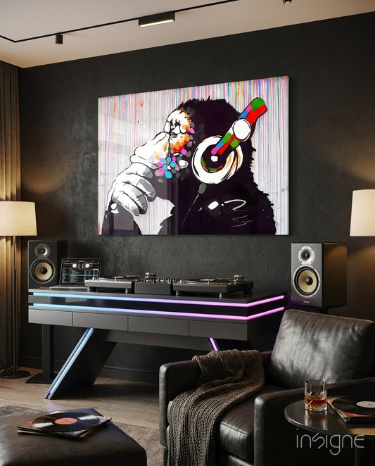 DJ Chimp glass wall art displayed above a DJ booth in a dark luxe lounge with neon LED accents and vinyl records