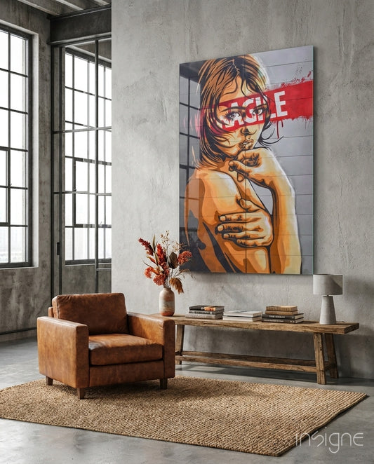 Fragile glass wall art displayed above a wood bench in an industrial concrete-walled lounge with brown leather chair