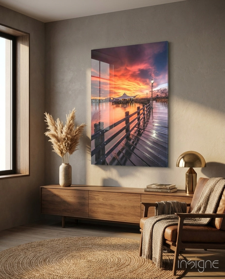 Pier Sunset glass wall art displayed above a walnut credenza in a warm minimalist nook with cognac leather chair