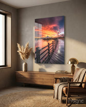 Pier Sunset glass wall art displayed above a walnut credenza in a warm minimalist nook with cognac leather chair