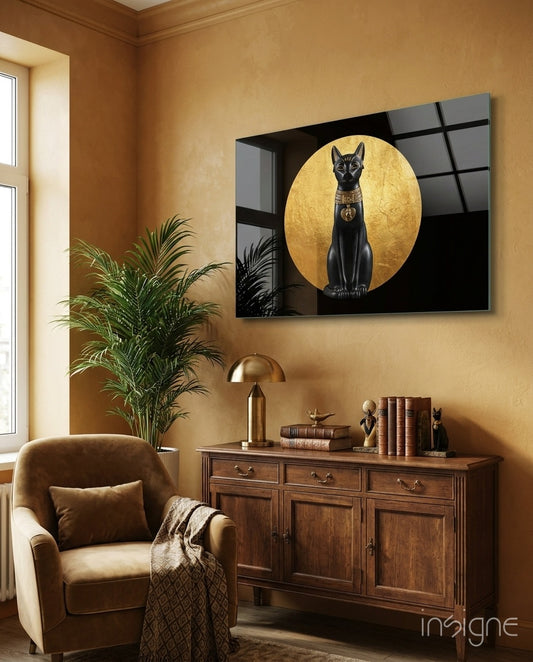 Bastet Statue glass wall art displayed above a wood credenza in a warm ochre-walled lounge with brown velvet armchair