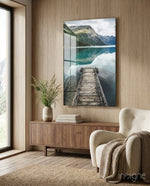 Dock glass wall art displayed above a walnut credenza in a warm wood-paneled lounge with bouclé armchair
