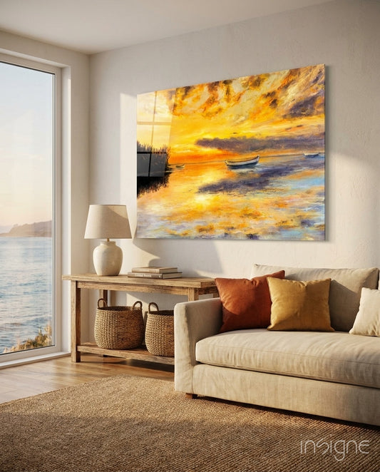 Landscape glass wall art displayed above a wood console in a soft white-walled lounge with linen sofa and ocean view