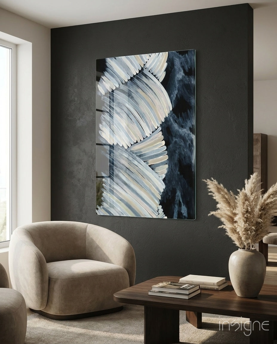 Abstract glass wall art displayed above a walnut coffee table in a moody charcoal-walled lounge with bouclé armchair and pampas vase