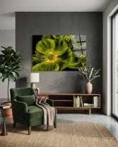 Malvales Flower glass wall art displayed above a walnut credenza in a soft charcoal-walled lounge with green velvet armchair and fiddle leaf fig