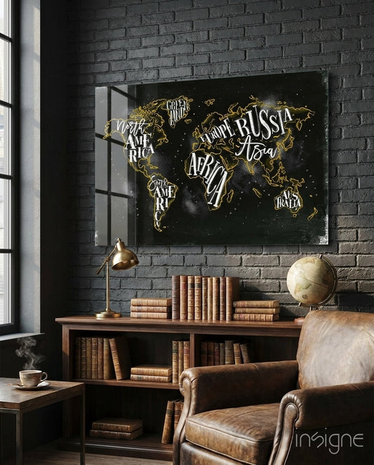 Modern World Map glass wall art displayed above a wood library shelf in a black brick-walled study with brass lamp and antique globe