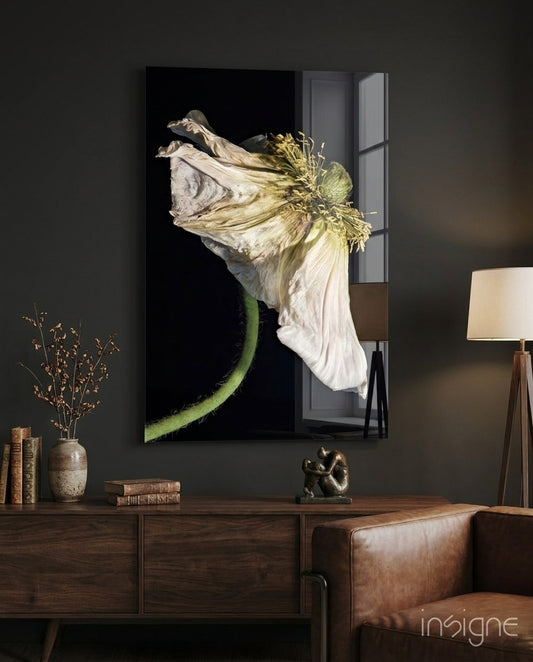 Flower glass wall art displayed above a walnut credenza in a moody charcoal-walled lounge with cognac armchair and dried botanicals