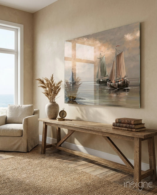 Sailboats glass wall art displayed above a rustic wood bench in a sand-toned hallway with linen armchair and pampas vase