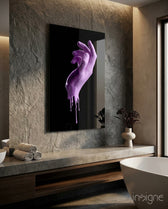 Hand glass wall art displayed above a stone vanity in a moody travertine-walled bathroom with freestanding tub