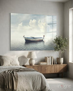 Marine glass wall art displayed above a wood credenza in a soft white-walled bedroom with linen bedding and olive tree
