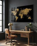 World Map glass wall art displayed above a rustic wood desk in a moody charcoal-walled office with cognac leather chair and brass lamp