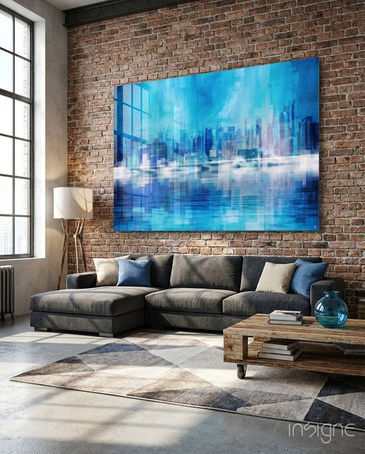 Abstract glass wall art displayed above a charcoal sectional in a brick-walled industrial lounge with wood floor lamp