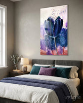 Tulip glass wall art displayed above a charcoal upholstered bed in a soft taupe-walled bedroom with violet velvet pillows