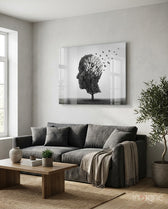 Autumn of Thoughts glass wall art displayed above a charcoal linen sofa in a soft white-plaster lounge with olive tree and stoneware vase