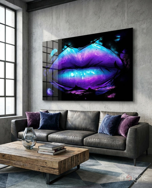 Lip glass wall art displayed above a gray leather sofa in a concrete-walled lounge with violet velvet pillows and reclaimed wood coffee table