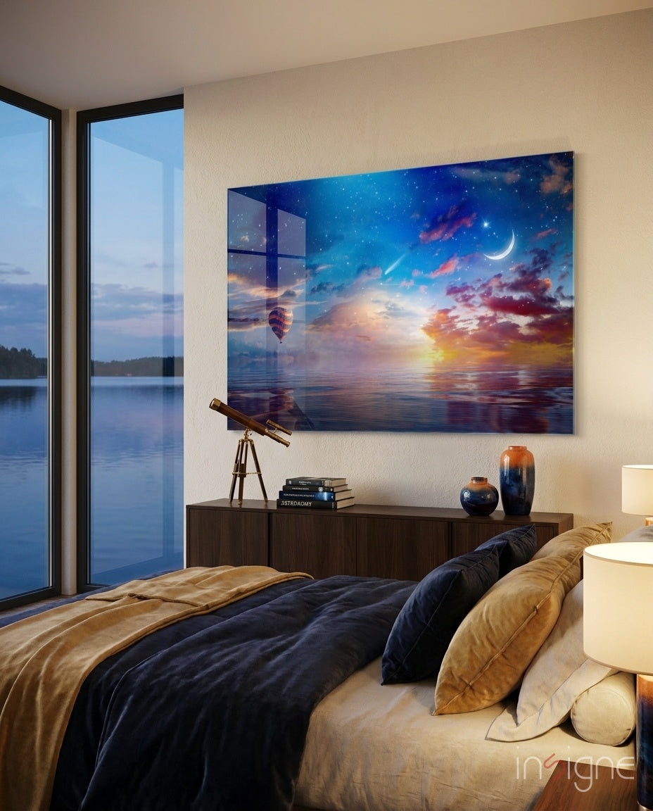Landscape glass wall art displayed above a dark wood console in a navy-walled bedroom with bronze telescope and lakeview window