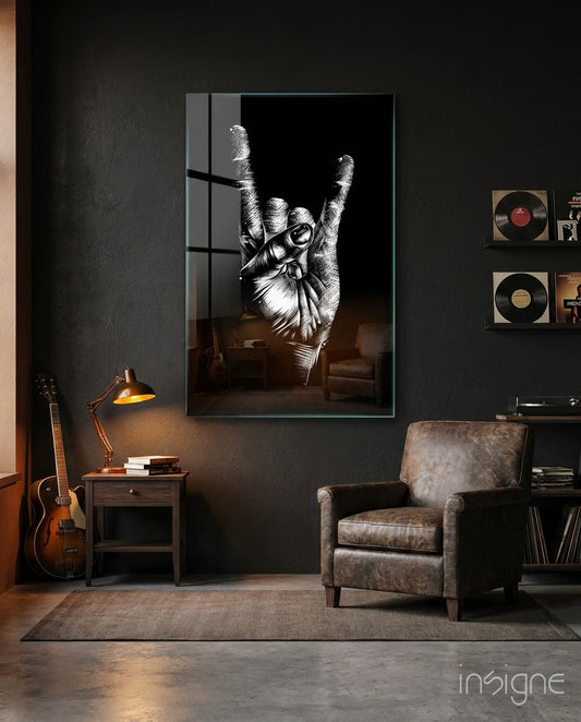 Horns Hands glass wall art displayed beside a leather armchair in a moody charcoal-walled lounge with vinyl records and guitar