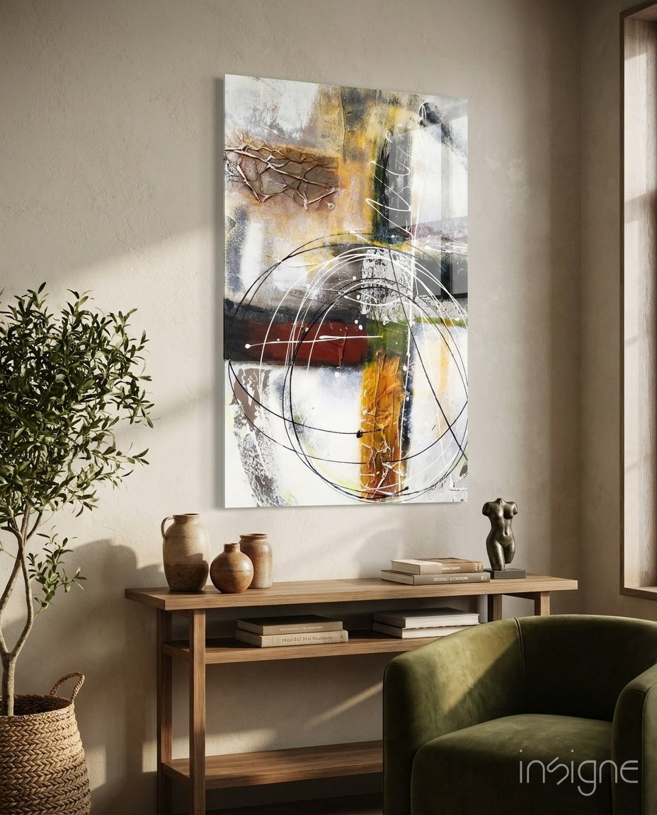 Abstract glass wall art displayed above a wood console in a soft beige-plaster hallway with olive tree and stoneware vases