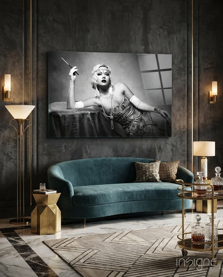 Roaring 20s glass wall art displayed above a teal velvet sofa in a paneled charcoal-walled lounge with brass sconces and marble floor