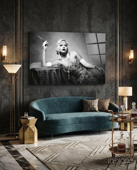 Roaring 20s glass wall art displayed above a teal velvet sofa in a paneled charcoal-walled lounge with brass sconces and marble floor