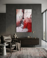Colors of Abstraction glass wall art displayed above a walnut credenza in a moody charcoal-walled hallway with leather armchair and stoneware vase