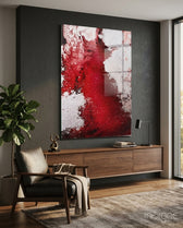 Colors of Abstraction glass wall art displayed above a walnut credenza in a moody charcoal-walled lounge with leather armchair and fiddle leaf fig